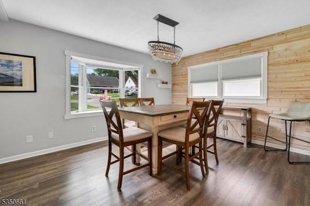 46 Sunrise Ter, Cedar Grove Twp, NJ 07009 - dining space featuring wood walls, a chandelier, dark wood-type flooring, and baseboards