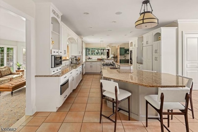 23 Stoningham Dr, Warren Twp, NJ 07059 - kitchen with stainless steel appliances, light tile patterned floors, a spacious island, a kitchen bar, and pendant lighting