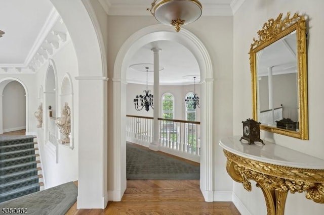 23 Stoningham Dr, Warren Twp, NJ 07059 - hallway with a chandelier, crown molding, wood finished floors, and arched walkways