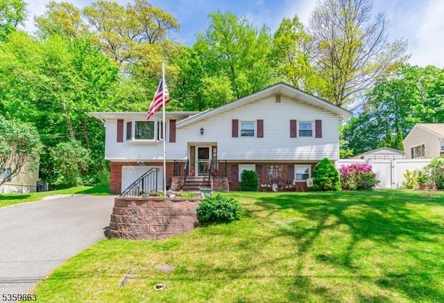 580 Eric Ln, Mount Arlington Boro, NJ 07850 - raised ranch with brick siding, asphalt driveway, and an attached garage