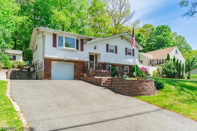 580 Eric Ln, Mount Arlington Boro, NJ 07850 - bi-level home with asphalt driveway, a garage, brick siding, and a front yard