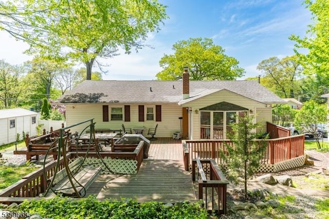 580 Eric Ln, Mount Arlington Boro, NJ 07850 - rear view of property featuring a deck, a chimney, and a shingled roof