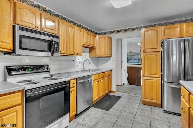580 Eric Ln, Mount Arlington Boro, NJ 07850 - kitchen featuring appliances with stainless steel finishes, a sink, light countertops, and decorative backsplash