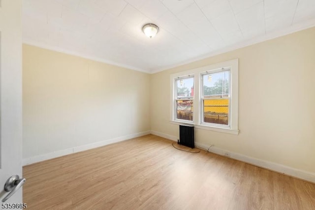 28 Beechwood Pl, Irvington Twp, NJ 07111 - empty room featuring radiator, wood finished floors, baseboards, and ornamental molding