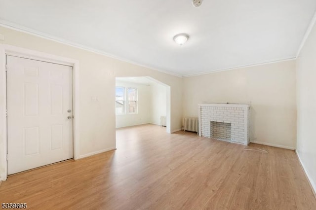28 Beechwood Pl, Irvington Twp, NJ 07111 - unfurnished living room featuring radiator heating unit, crown molding, wood finished floors, a fireplace, and baseboards