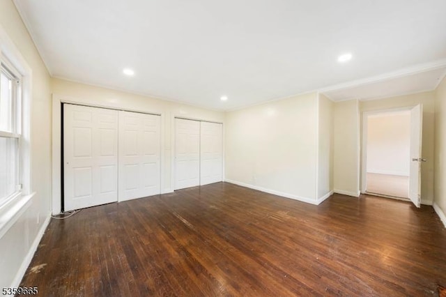 28 Beechwood Pl, Irvington Twp, NJ 07111 - unfurnished bedroom with two closets, hardwood / wood-style flooring, baseboards, and recessed lighting