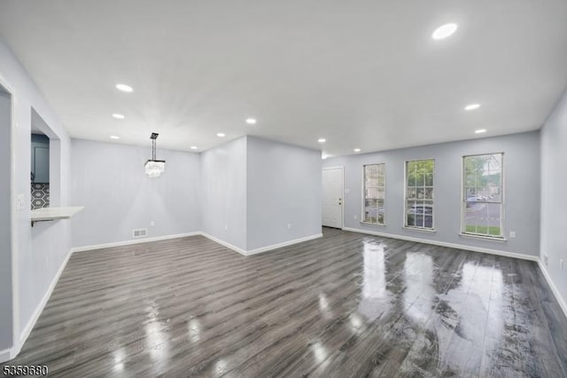 173 Gregory Ln, Franklin Twp, NJ 08823 - unfurnished living room with baseboards, dark wood finished floors, recessed lighting, and a chandelier