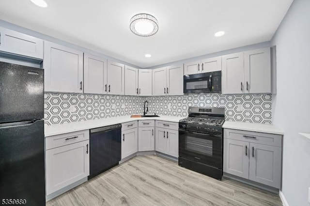 173 Gregory Ln, Franklin Twp, NJ 08823 - kitchen featuring black appliances, light countertops, light wood finished floors, backsplash, and recessed lighting