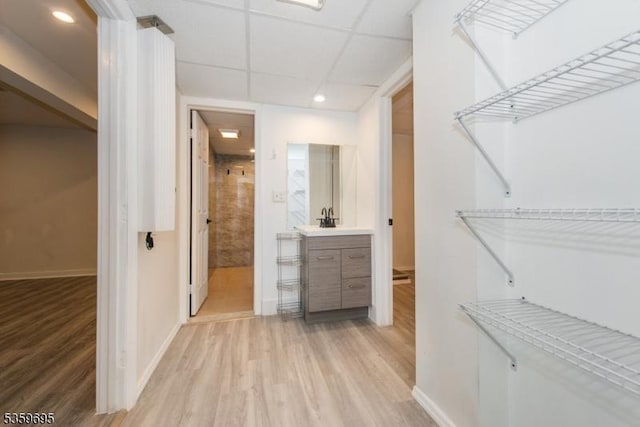 76 Trafalgar Ct, Sparta Twp, NJ 07871 - walk in closet with light wood-style flooring, a paneled ceiling, and a sink
