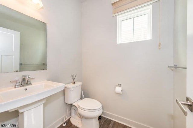 76 Trafalgar Ct, Sparta Twp, NJ 07871 - half bathroom featuring baseboards, toilet, and wood finished floors