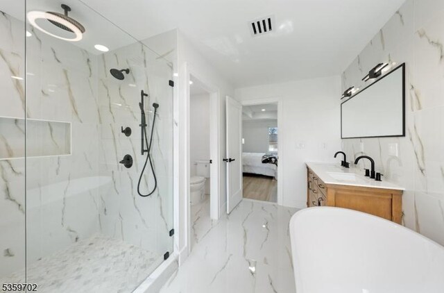 107 Myrtle St, Cranford Twp, NJ 07016 - full bathroom featuring marble tiled flooring, a marble finish shower, vanity, toilet, and a freestanding tub