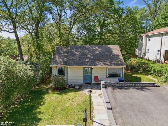 4 Erie Ave, Rockaway Twp, NJ 07866 - view of front of house with a front yard, a shingled roof, and cooling unit
