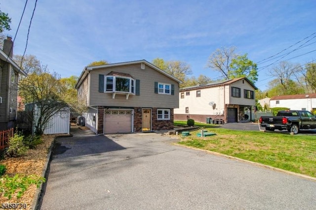 30 Acorn St, Byram Twp, NJ 07874 - view of front of home featuring an attached garage, driveway, a front lawn, and a storage shed