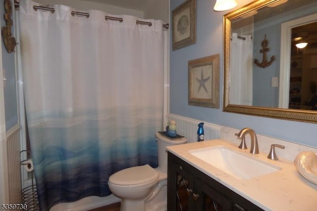 8153 Ashland Ct, Stanhope Boro, NJ 07874 - bathroom with wainscoting, vanity, toilet, and a shower with shower curtain