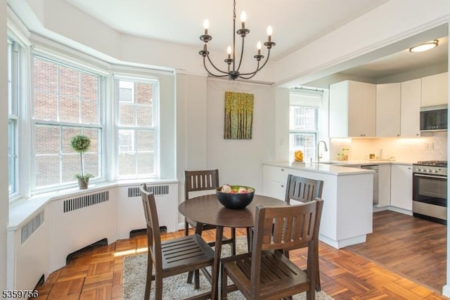 10 Crestmont Rd Unit 3F, Montclair Twp, NJ 07042 - dining area featuring radiator heating unit and a chandelier