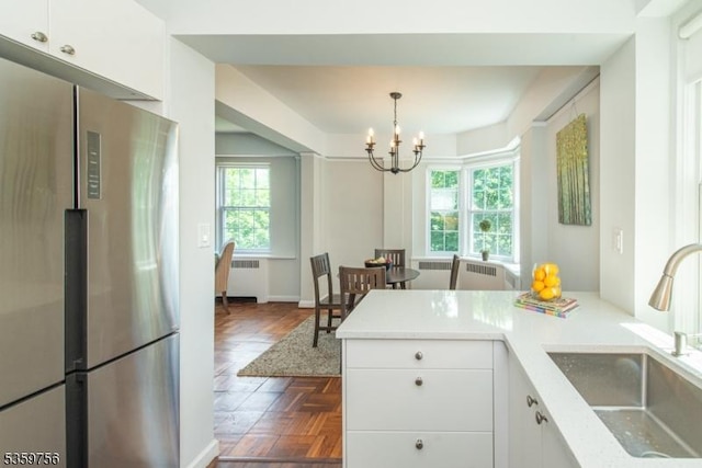 10 Crestmont Rd Unit 3F, Montclair Twp, NJ 07042 - kitchen with freestanding refrigerator, radiator, a sink, white cabinetry, and a chandelier