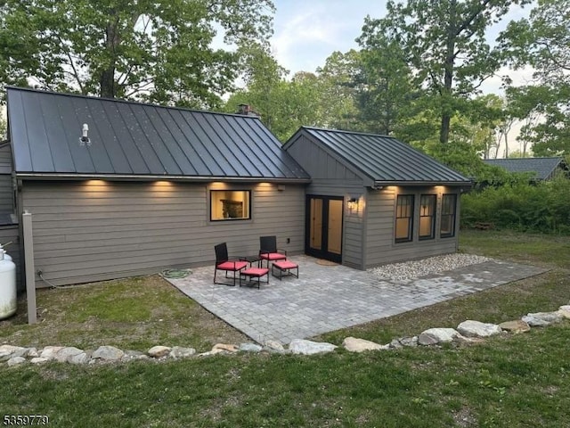 24 Lakeview Point Ave, Frankford Twp, NJ 07826 - rear view of house with a standing seam roof, metal roof, and a patio area