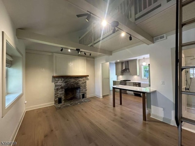 24 Lakeview Point Ave, Frankford Twp, NJ 07826 - unfurnished living room with track lighting, wood finished floors, beam ceiling, baseboards, and a stone fireplace