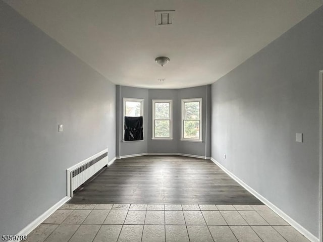 207 Tremont Ave, East Orange City, NJ 07018 - tiled spare room featuring radiator and baseboards