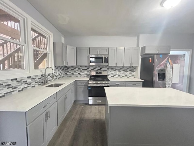 207 Tremont Ave, East Orange City, NJ 07018 - kitchen featuring appliances with stainless steel finishes, gray cabinetry, a sink, and dark wood finished floors