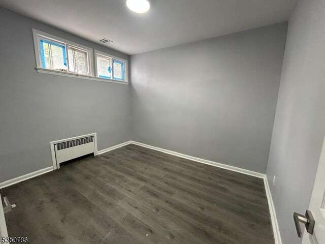 207 Tremont Ave, East Orange City, NJ 07018 - spare room with radiator heating unit, baseboards, and dark wood-style floors