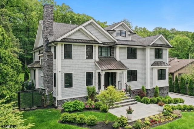 290 Long Hill Dr, Millburn Twp, NJ 07078 - shingle-style home with a standing seam roof, a chimney, a front yard, a shingled roof, and metal roof