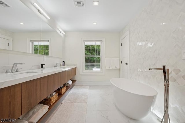 290 Long Hill Dr, Millburn Twp, NJ 07078 - bathroom with marble finish flooring, double vanity, a soaking tub, and baseboards