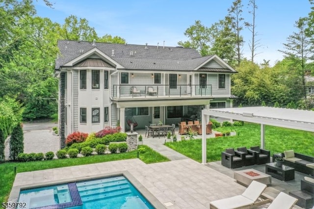290 Long Hill Dr, Millburn Twp, NJ 07078 - rear view of property featuring a balcony, an outdoor living space with a fire pit, a patio area, an outdoor pool, and outdoor dining space