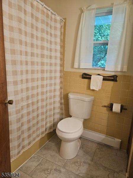38 Summerfield Rd, White Twp, NJ 07823 - full bath with baseboard heating, a shower with curtain, tile walls, tile patterned flooring, and wainscoting
