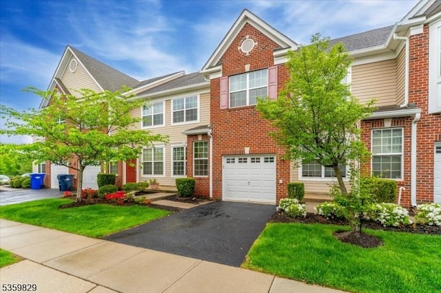 2420 Canterbury Ln, North Brunswick Twp, NJ 08902 - multi unit property with brick siding, an attached garage, driveway, and a front lawn