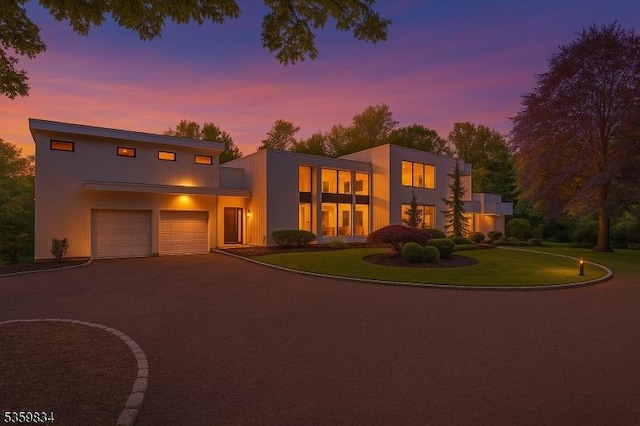 41 Park Way W, Orange Twp, NJ 07052 - contemporary house with driveway, an attached garage, and a lawn