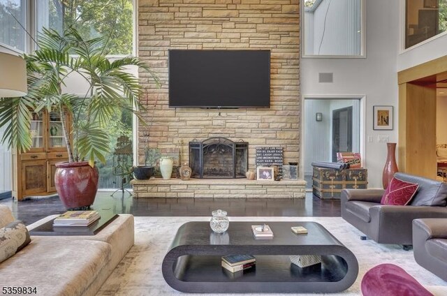41 Park Way W, Orange Twp, NJ 07052 - living room featuring a stone fireplace, a high ceiling, and wood finished floors