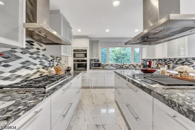 41 Park Way W, Orange Twp, NJ 07052 - kitchen featuring wall chimney range hood, stainless steel appliances, decorative backsplash, and recessed lighting