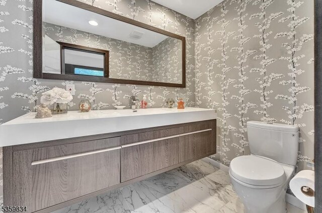 41 Park Way W, Orange Twp, NJ 07052 - half bathroom featuring vanity, toilet, baseboards, and marble finish floors
