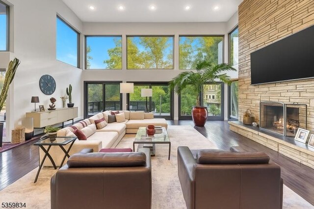 41 Park Way W, Orange Twp, NJ 07052 - living area featuring a high ceiling, wood finished floors, a stone fireplace, and recessed lighting
