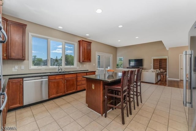 28 Lavada Ln, Raritan Twp, NJ 08551 - kitchen featuring dishwasher, dark countertops, open floor plan, a kitchen island, and light tile patterned flooring