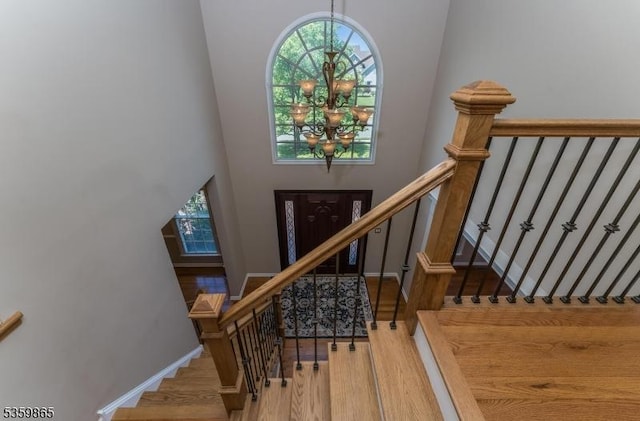 28 Lavada Ln, Raritan Twp, NJ 08551 - stairway featuring wood finished floors, a chandelier, and a high ceiling