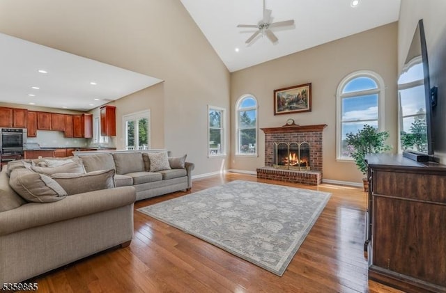 28 Lavada Ln, Raritan Twp, NJ 08551 - living room featuring high vaulted ceiling, ceiling fan, wood finished floors, a brick fireplace, and recessed lighting