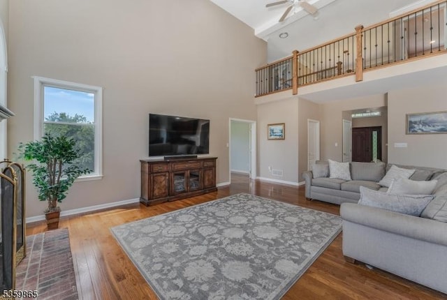 28 Lavada Ln, Raritan Twp, NJ 08551 - living room featuring a towering ceiling, ceiling fan, wood finished floors, and baseboards