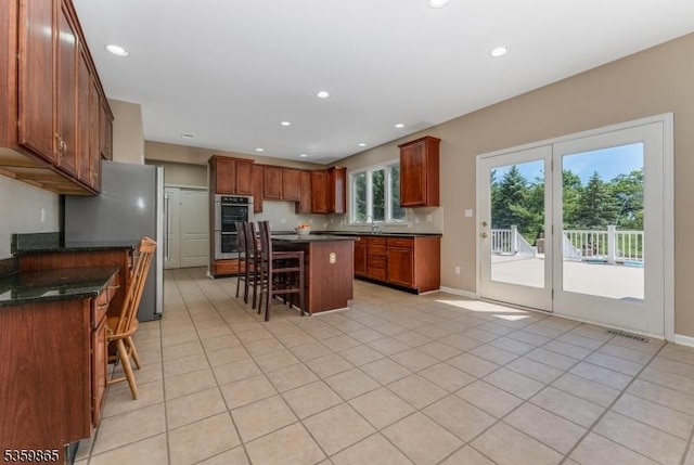 28 Lavada Ln, Raritan Twp, NJ 08551 - kitchen with stainless steel appliances, a kitchen breakfast bar, light tile patterned floors, a kitchen island, and a sink