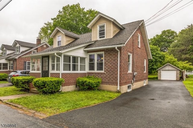 10 N Clark St, Ogdensburg Boro, NJ 07439 - cape cod-style house with brick siding, a detached garage, an outbuilding, and roof with shingles