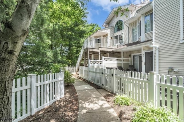 65 Academy Ct, Bedminster Twp, NJ 07921 - view of side of home featuring a fenced front yard and stairs