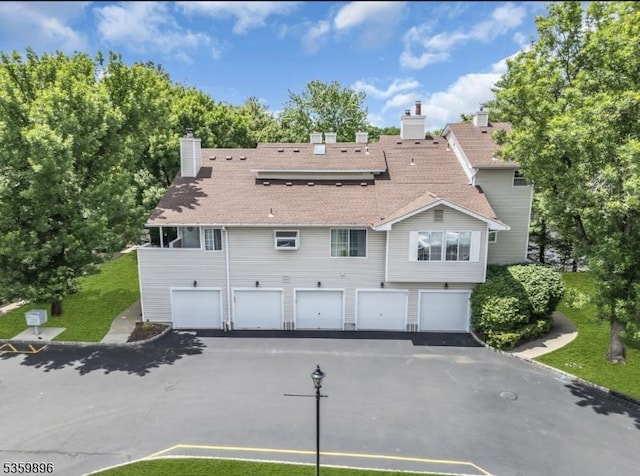 65 Academy Ct, Bedminster Twp, NJ 07921 - back of property featuring driveway, a garage, and a shingled roof