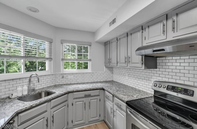 65 Academy Ct, Bedminster Twp, NJ 07921 - kitchen featuring stainless steel range with electric cooktop, a sink, under cabinet range hood, backsplash, and light stone counters