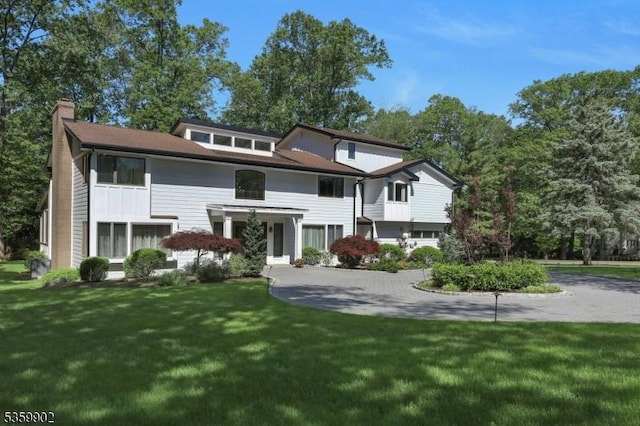 24 Partridge Run, Montvale Boro, NJ 07645 - view of front of house featuring a chimney and a front lawn