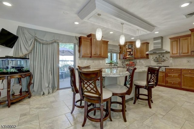24 Partridge Run, Montvale Boro, NJ 07645 - kitchen featuring wall chimney range hood, brown cabinetry, recessed lighting, decorative backsplash, and a kitchen island