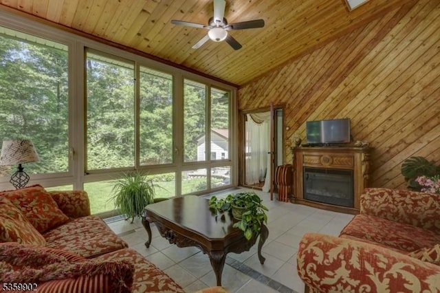 24 Partridge Run, Montvale Boro, NJ 07645 - living room with light tile patterned floors, healthy amount of natural light, ceiling fan, vaulted ceiling, and a glass covered fireplace