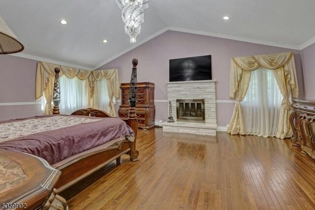 24 Partridge Run, Montvale Boro, NJ 07645 - bedroom with hardwood / wood-style floors, multiple windows, lofted ceiling, a fireplace, and ornamental molding
