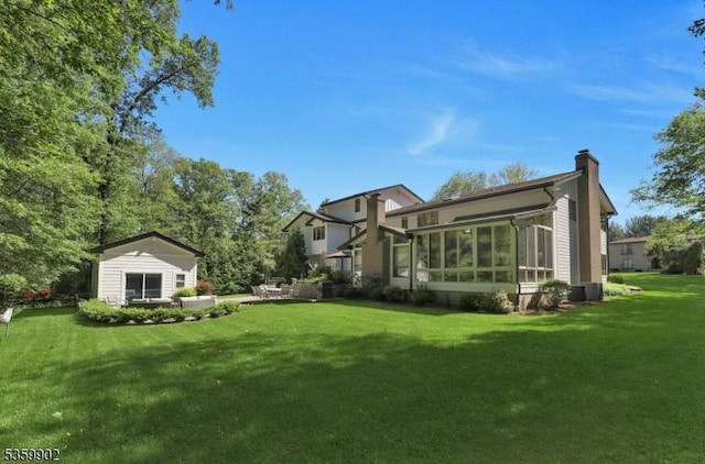 24 Partridge Run, Montvale Boro, NJ 07645 - back of house featuring a chimney, a yard, a sunroom, and central AC