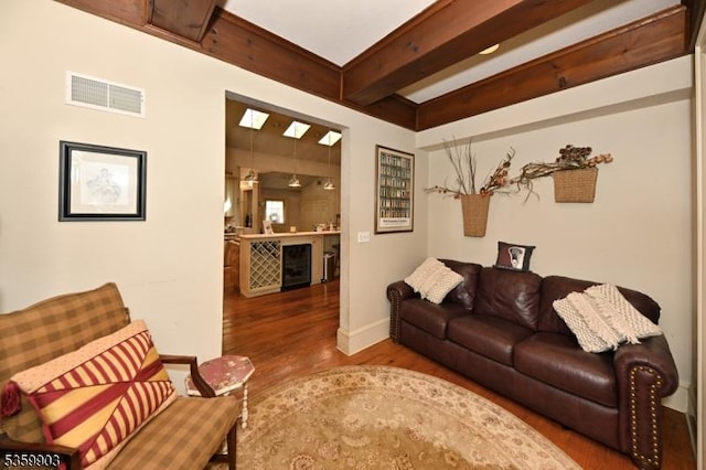 777 E Ridgewood Ave, Ridgewood Village, NJ 07450 - living area featuring wood finished floors, baseboards, beam ceiling, and beverage cooler